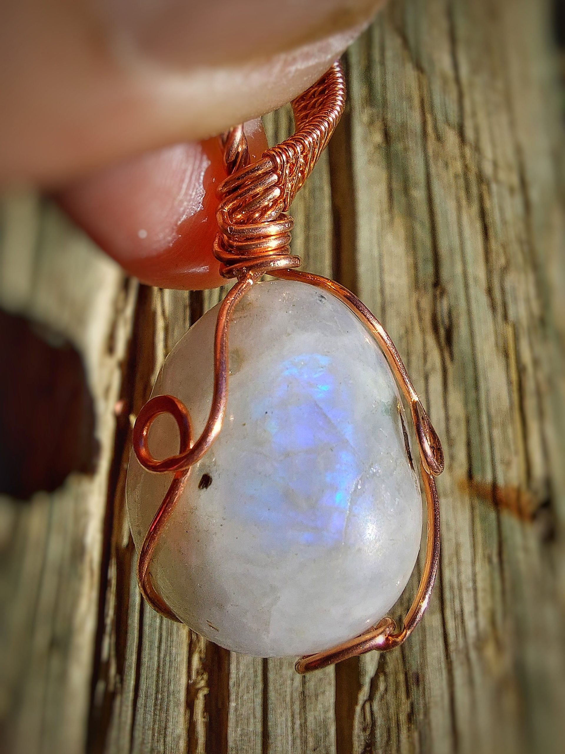 Moonstone pendant wrapped in copper wire front view
