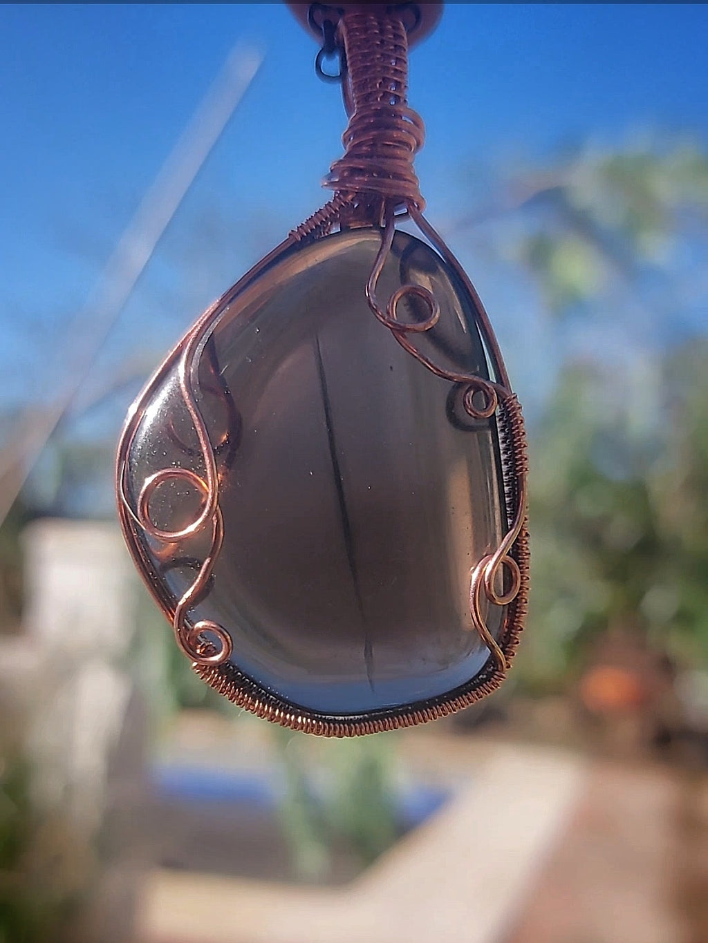 Smoking Quartz Dragon Eye pendant hand wrapped in copper wire close-up