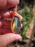 Handcrafted labradorite pendant from Madagascar wrapped in copper wire