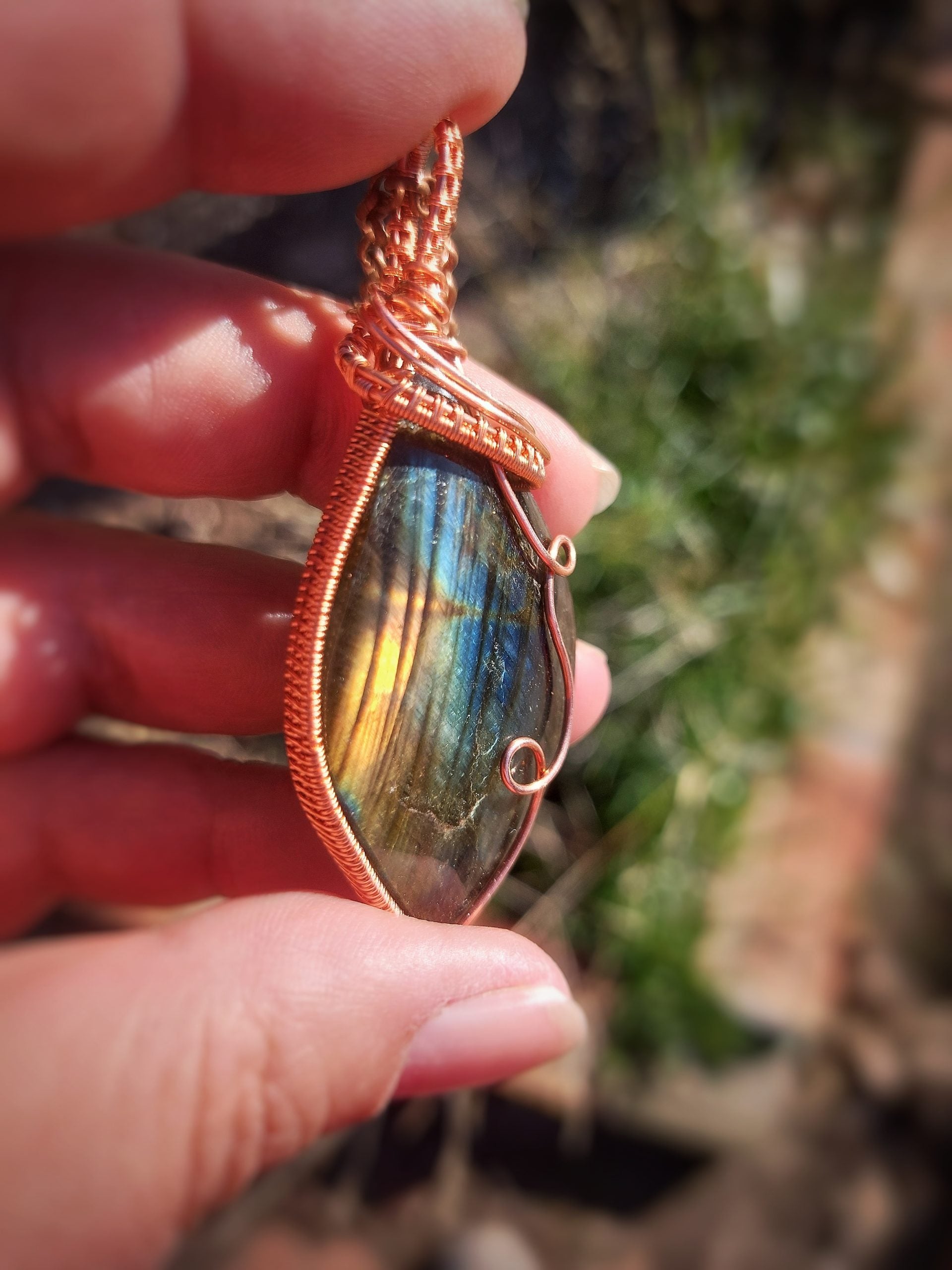 Handcrafted labradorite pendant from Madagascar wrapped in copper wire