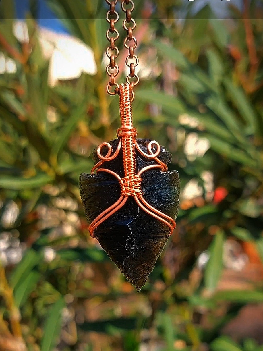 Obsidian spearpoint crystal pendant wrapped in copper wire – front view