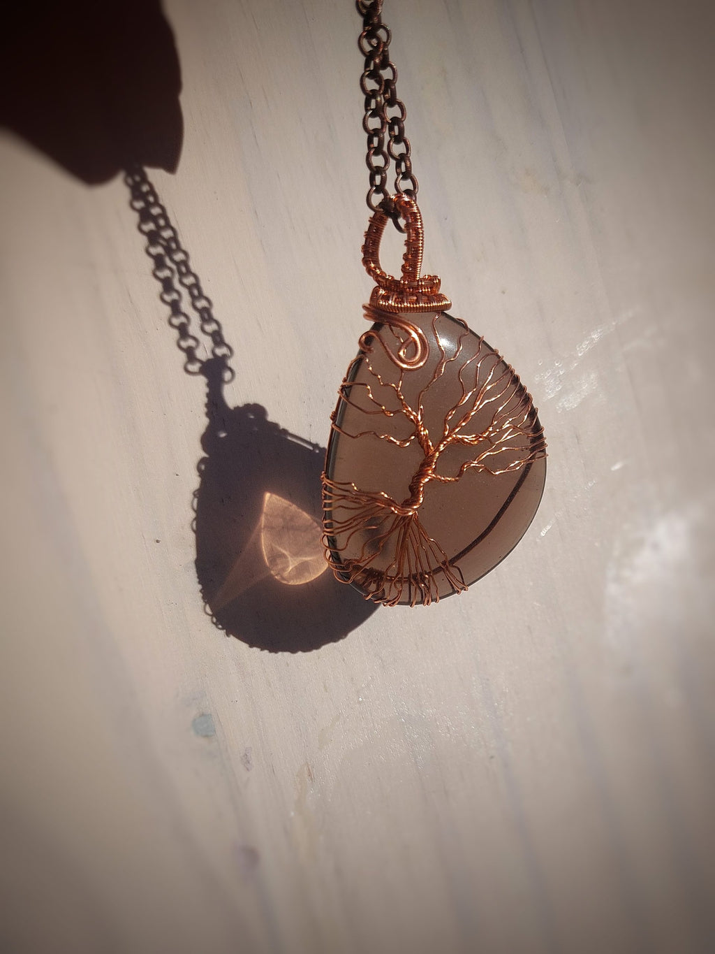 Front view of smoky quartz pendant with copper Tree of Life design