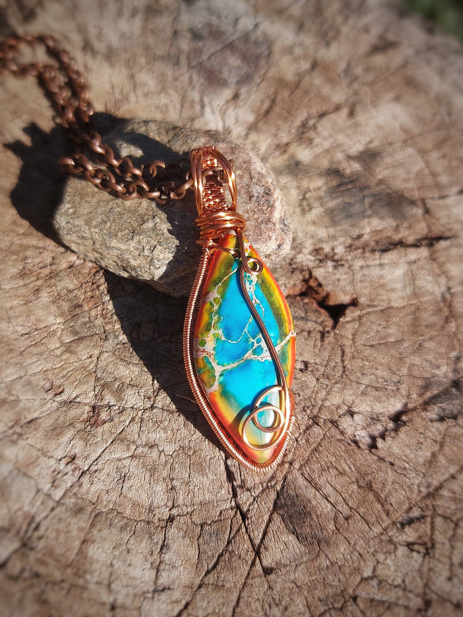 Front view of calsilica copper wrapped pendant