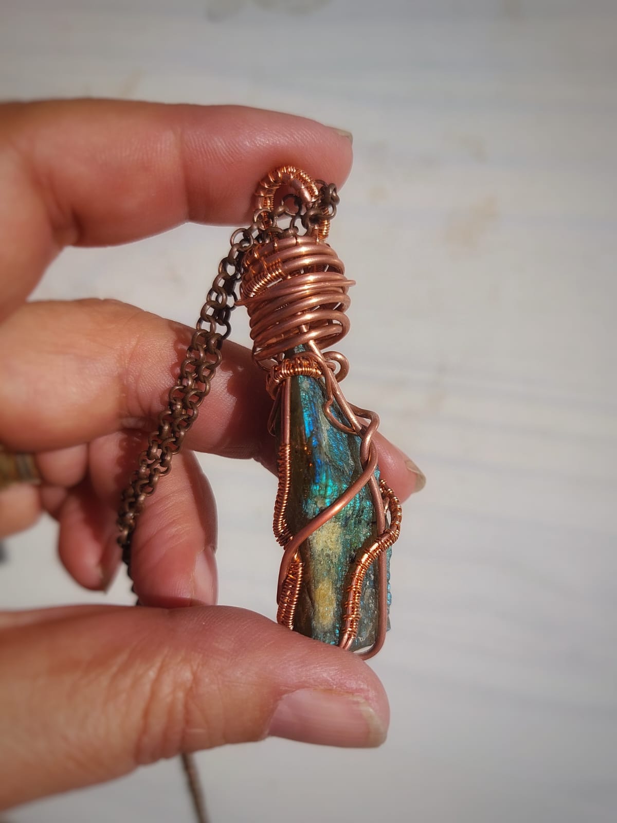 Side view of labradorite copper wire wrapped pendant necklace, raw crystal jewelry handmade with organic copper wire design