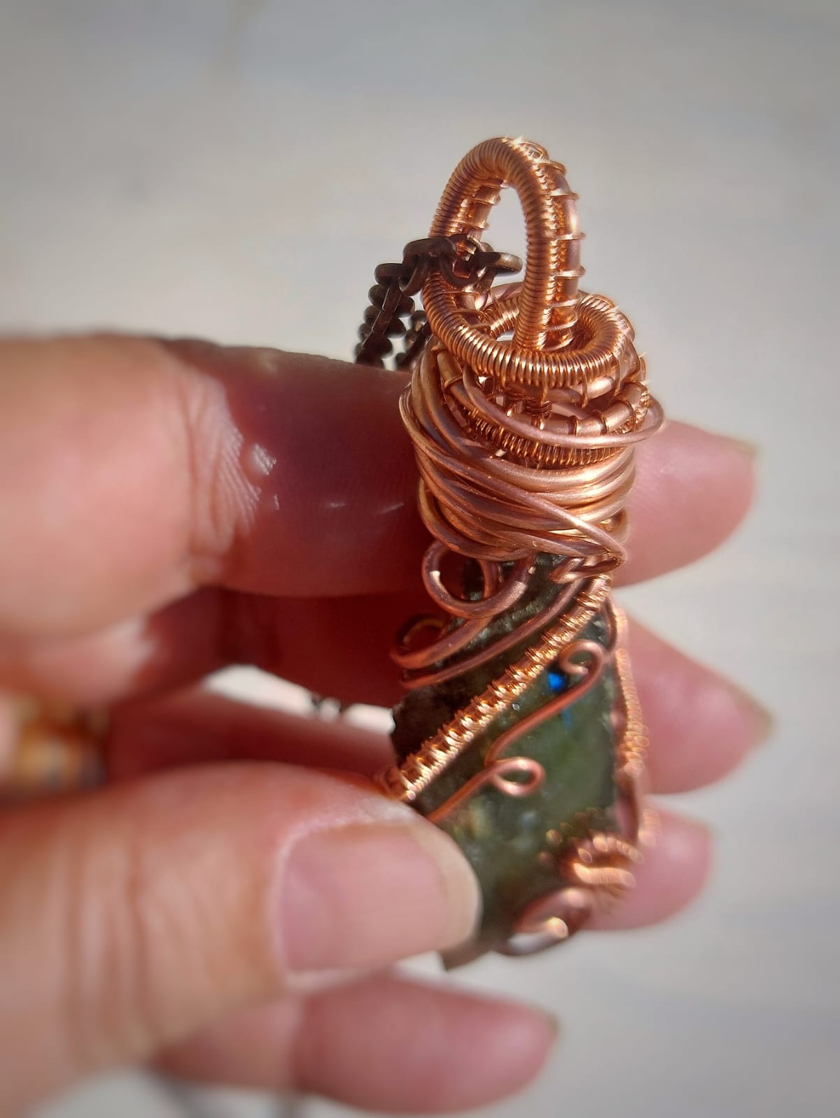 Top detail of copper wire wrapped labradorite pendant, handmade crystal jewelry with secure wire bail and natural stone