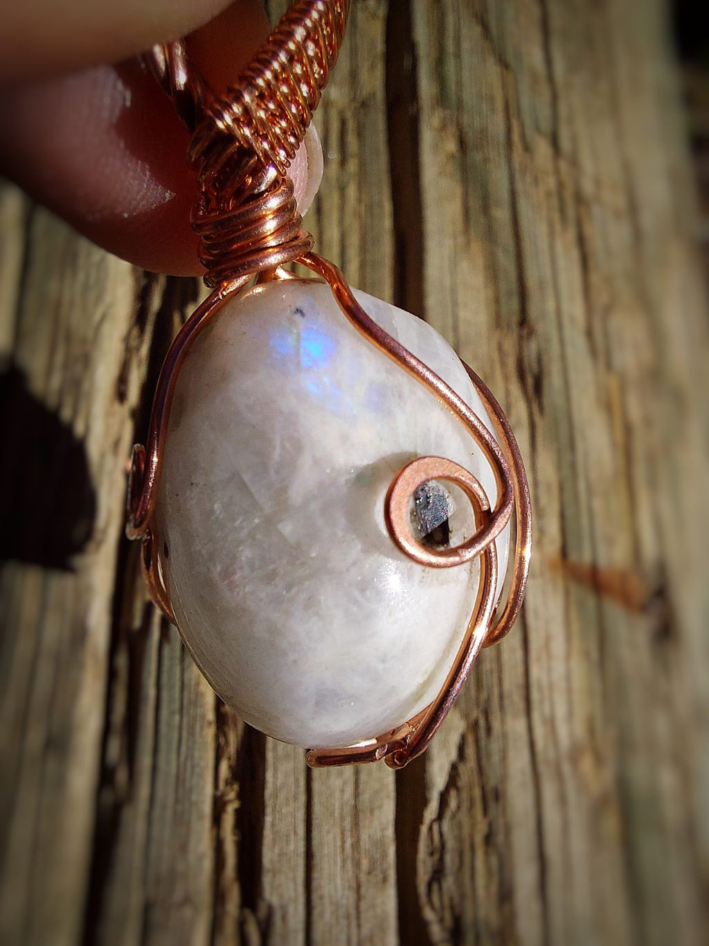 Natural moonstone gemstone wrapped in copper wire