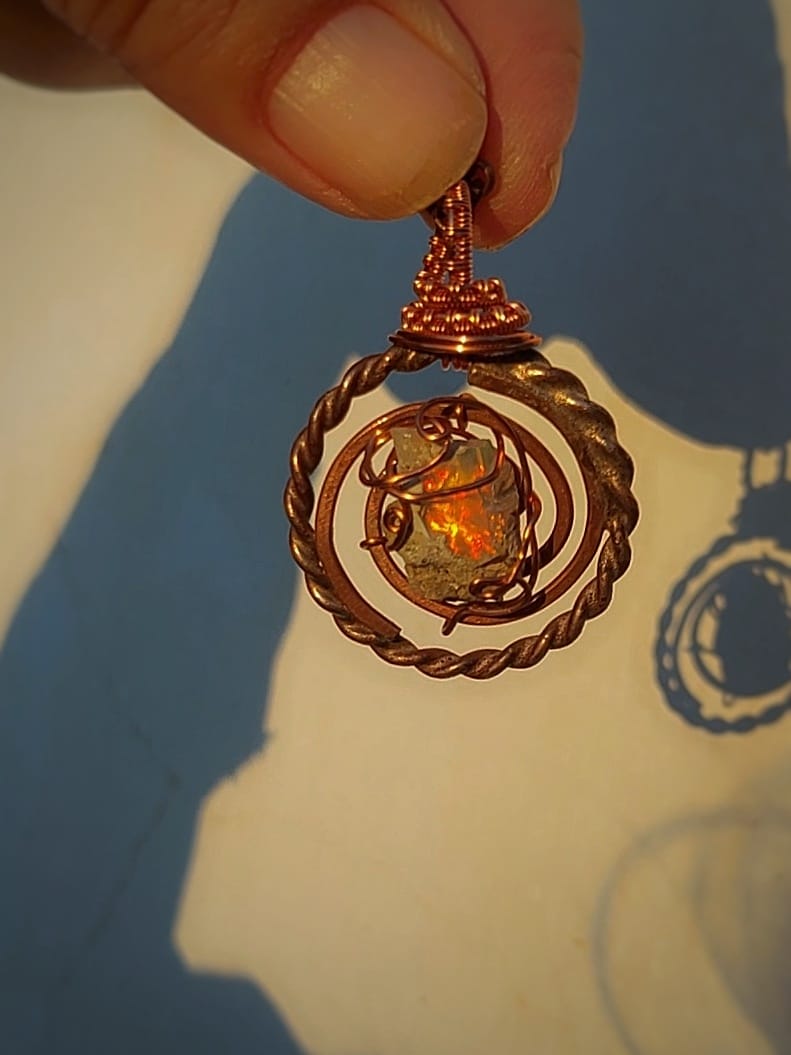 Detail view of opal Tesla coil necklace with sacred cubit ring design