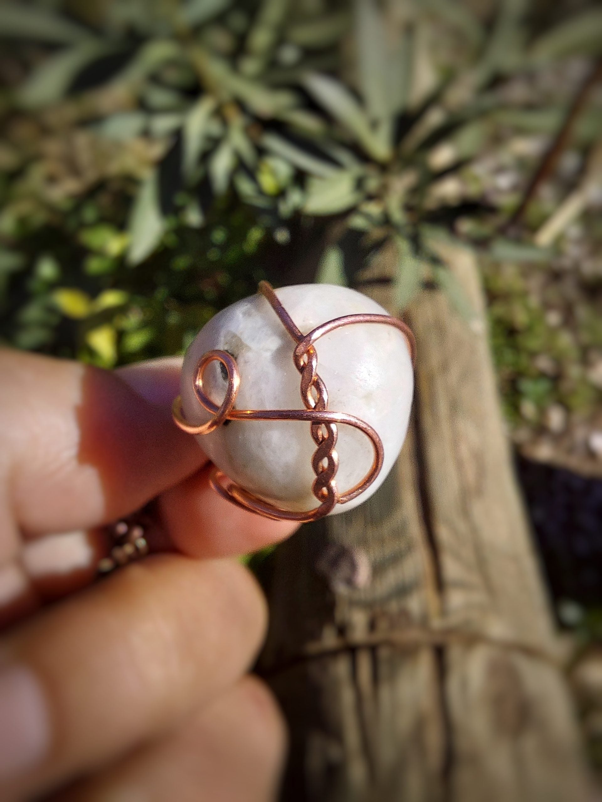 Moonstone crystal pendant held in hand