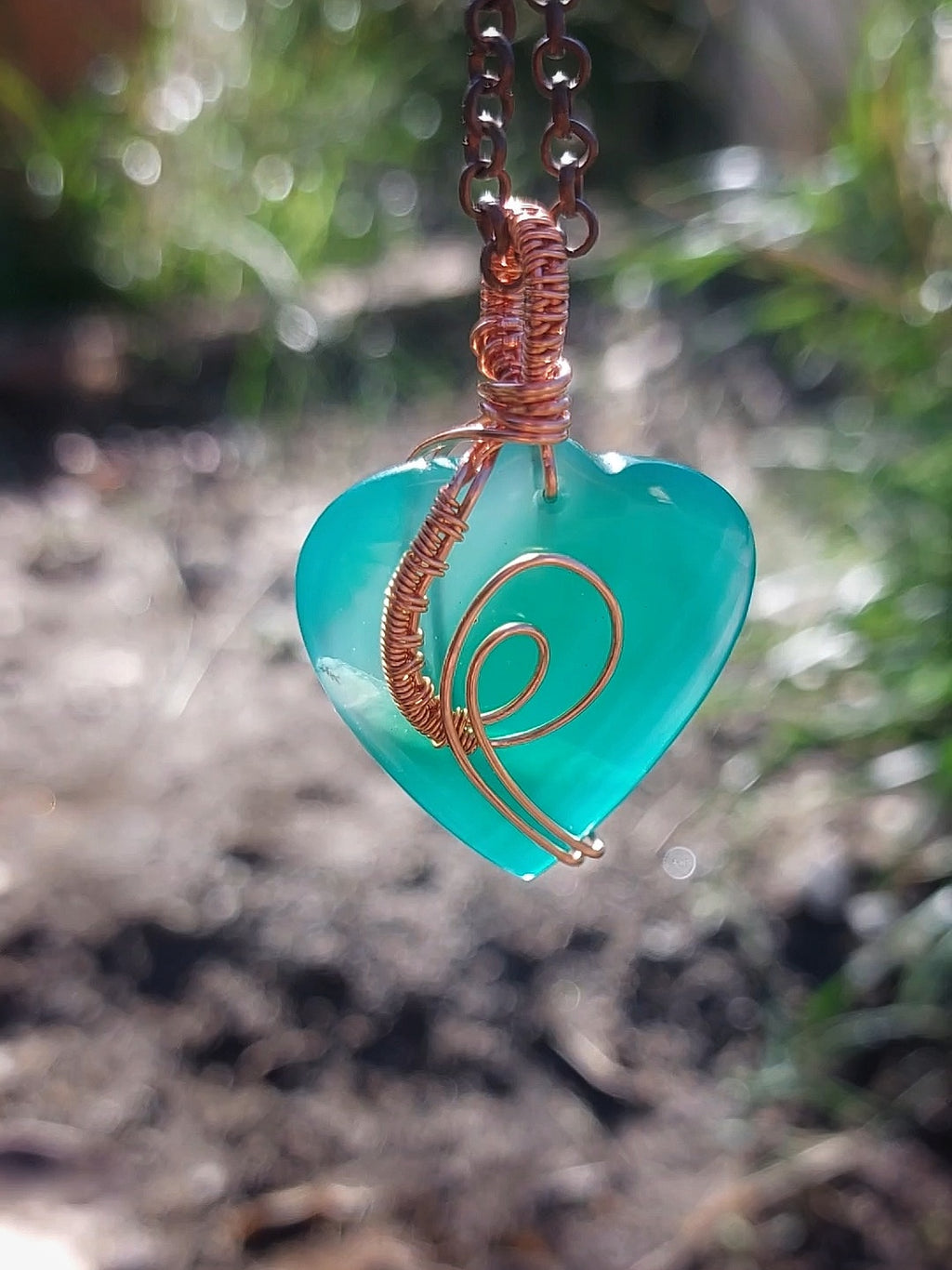 Handcrafted green heart-shaped agate pendant wrapped in copper wire